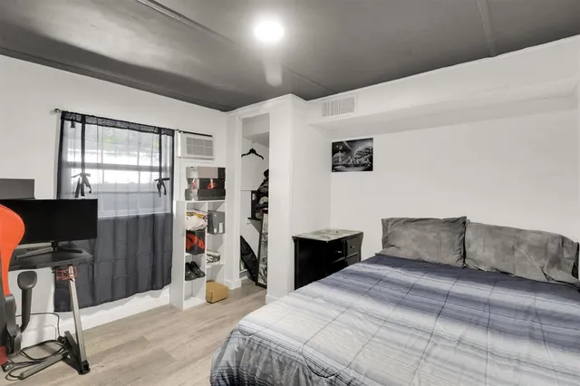 a bedroom with a bed and a desk