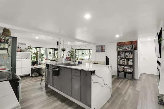 a view of a living room kitchen and a wooden floor