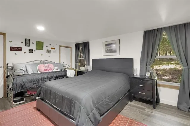 a bedroom with bed and window