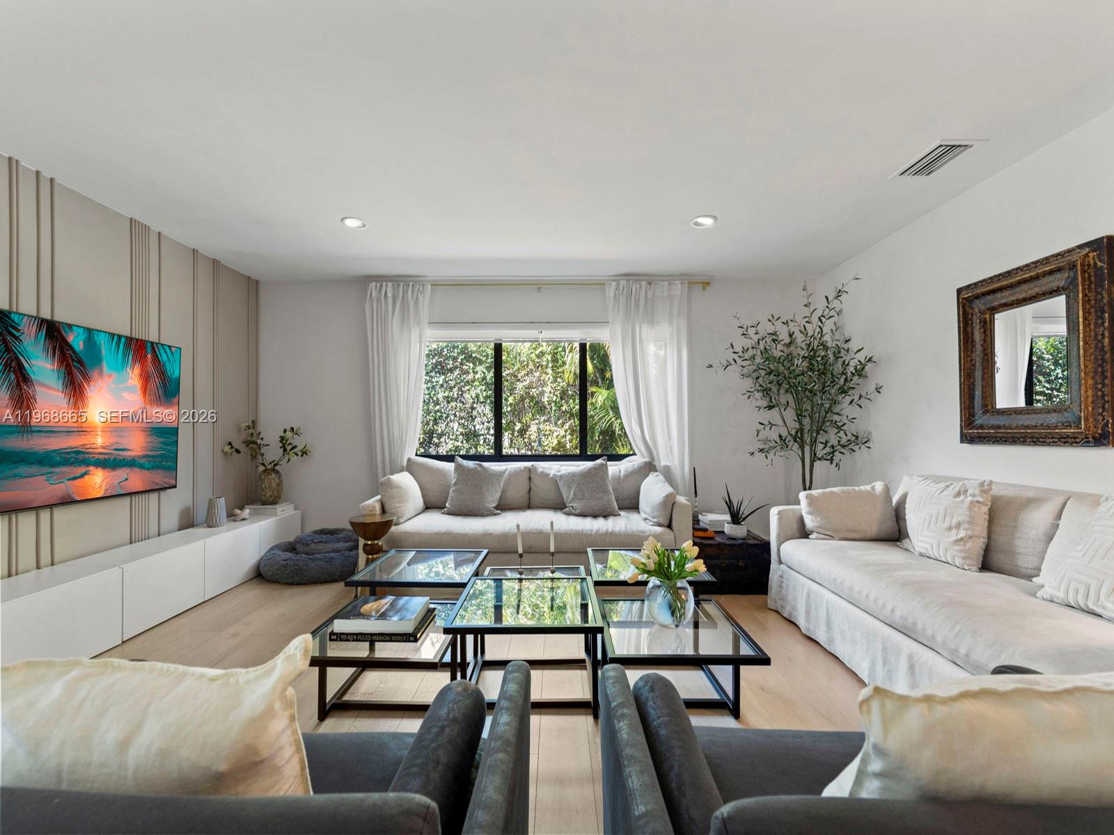 7731 Southwest 18th Terrace Miami, FL 33155 - Photo 1 of 50 a living room with furniture and a flat screen tv