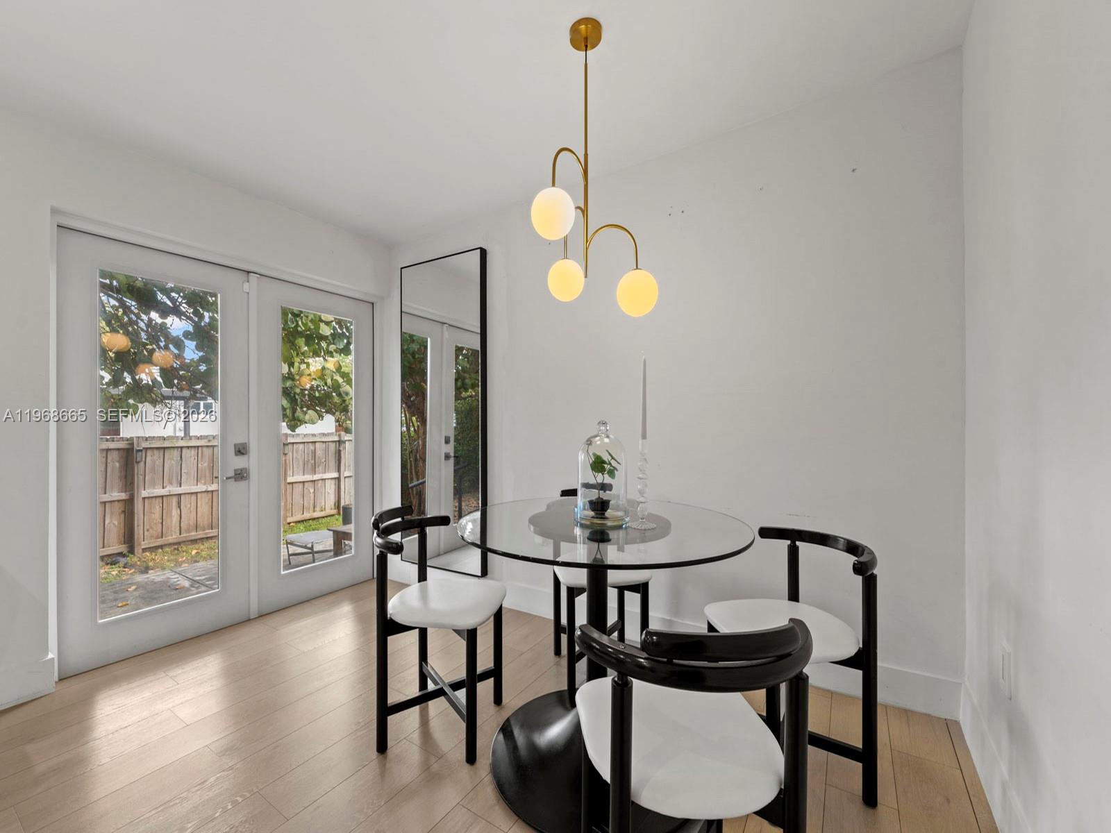 7731 Southwest 18th Terrace Miami, FL 33155 - Photo 13 of 50 a view of a dining room with furniture and wooden floor