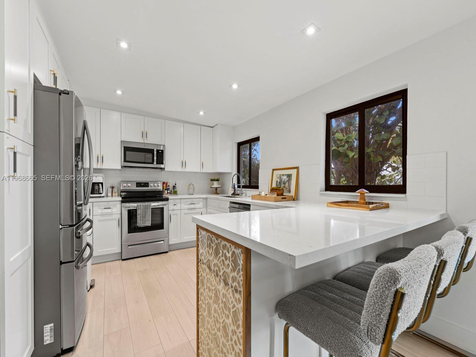7731 Southwest 18th Terrace Miami, FL 33155 - Photo 15 of 50 a kitchen with refrigerator cabinets and furniture