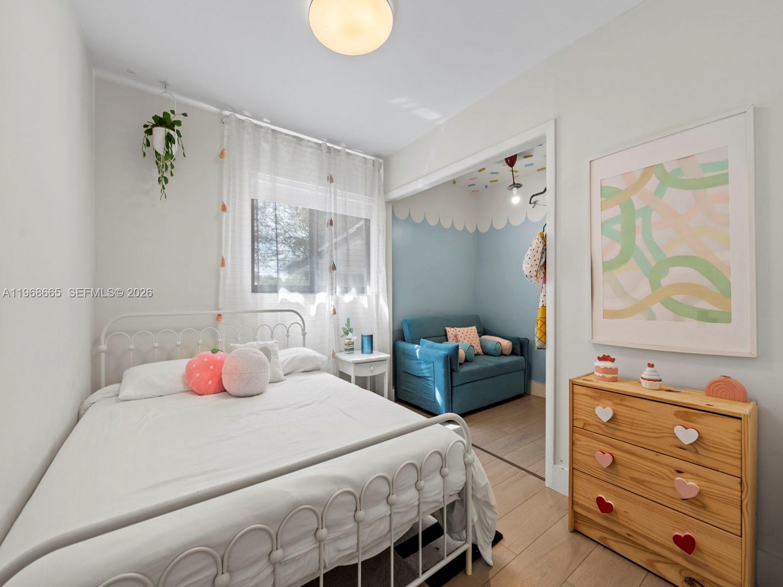 7731 Southwest 18th Terrace Miami, FL 33155 - Photo 21 of 50 a bedroom with a bed and wooden floor