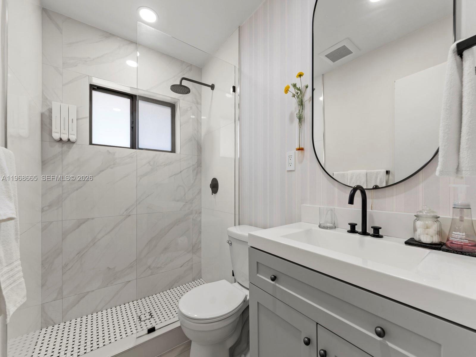 7731 Southwest 18th Terrace Miami, FL 33155 - Photo 23 of 50 a bathroom with a sink a toilet and shower