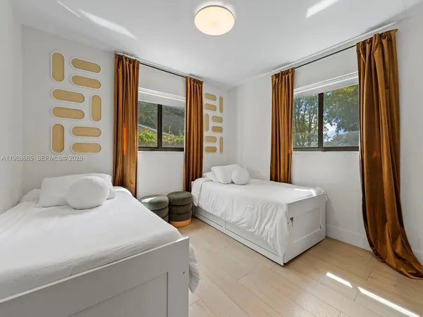 a bedroom with a bed and a large window