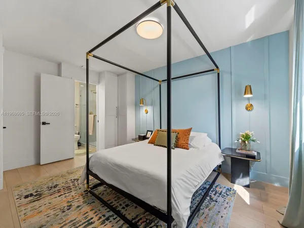 a bedroom with a bed and a chandelier