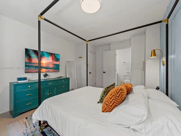 a bedroom with a bed and a dresser