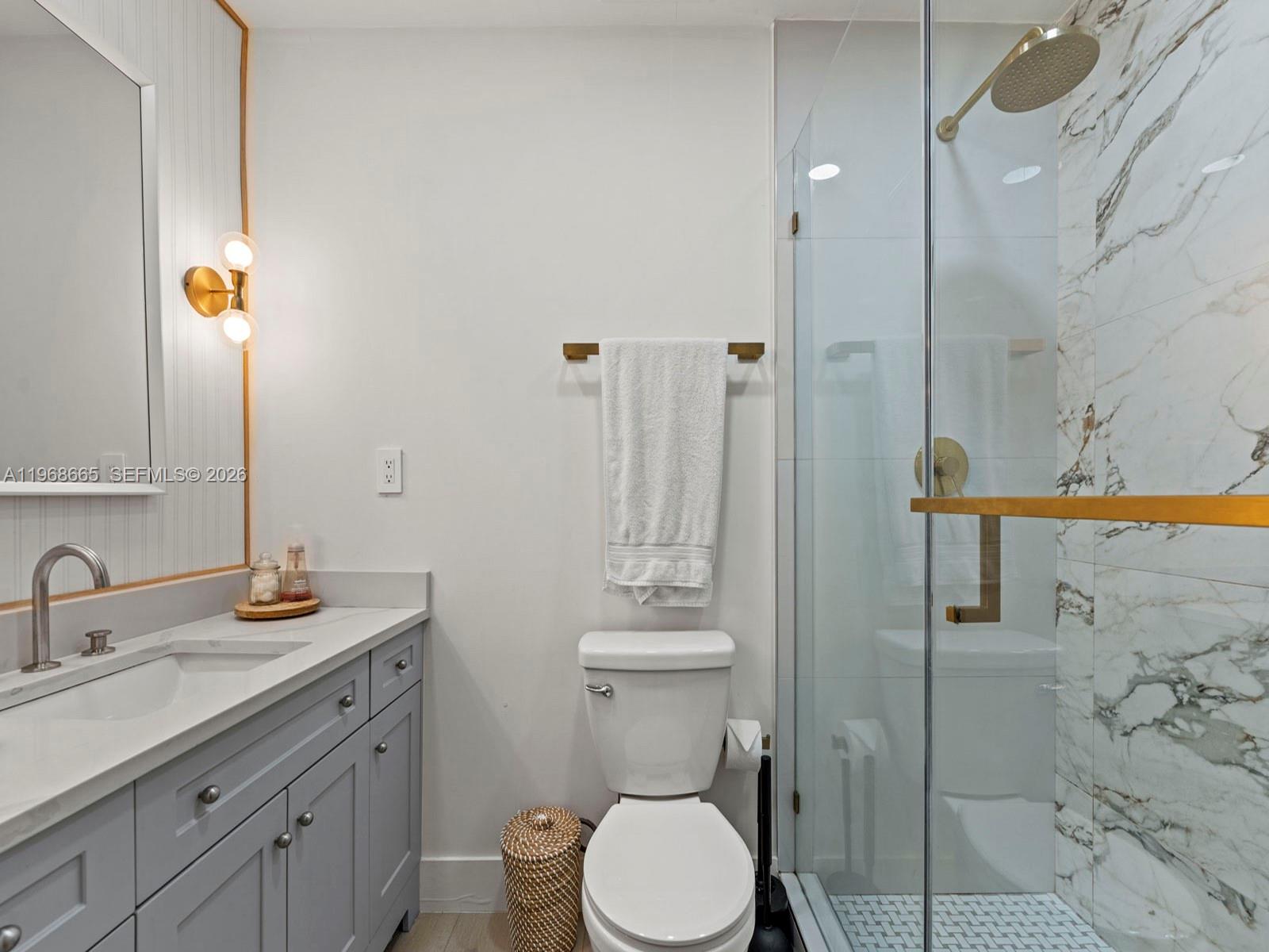 7731 Southwest 18th Terrace Miami, FL 33155 - Photo 29 of 50 a bathroom with a granite countertop sink toilet and shower