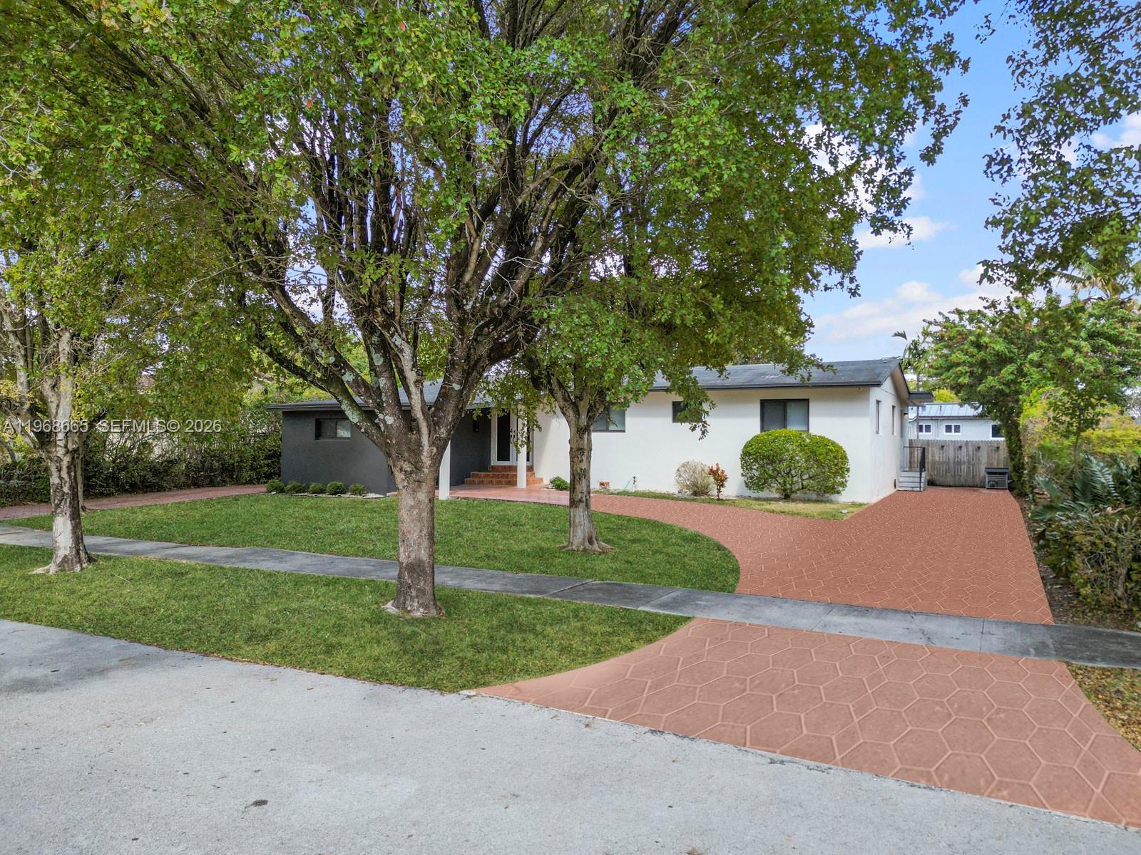 7731 Southwest 18th Terrace Miami, FL 33155 - Photo 44 of 50 a front view of a house with garden