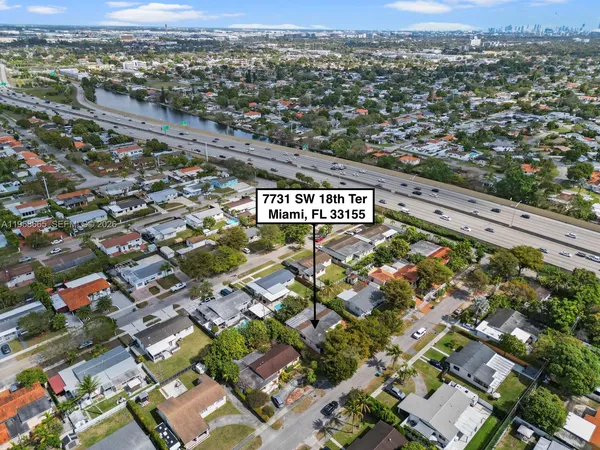 an aerial view of residential houses with city view