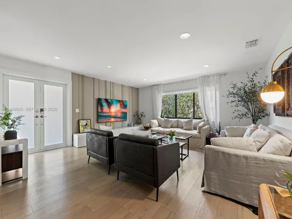 a living room with furniture and a flat screen tv