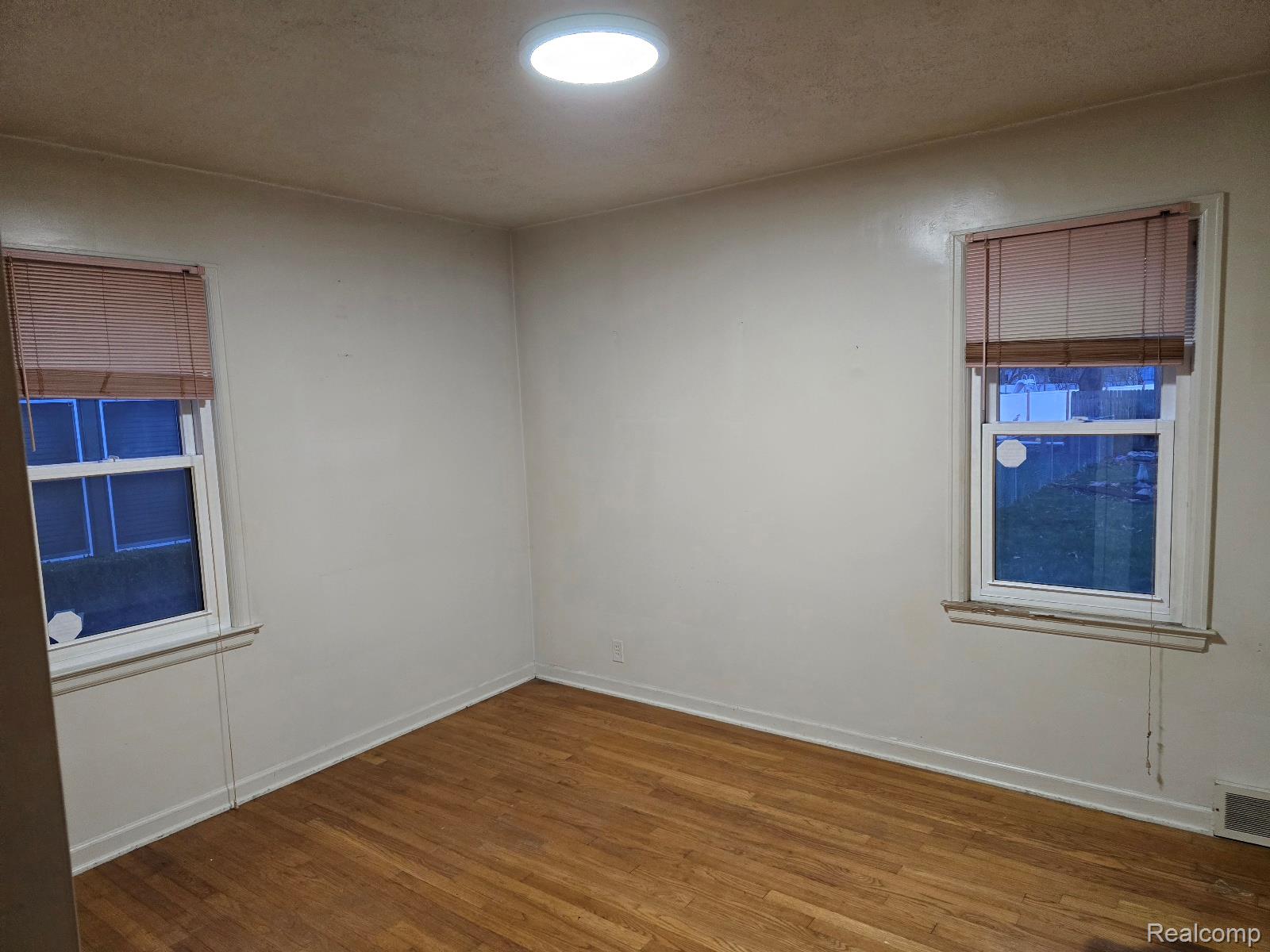 803 Commonwealth Avenue Flint, MI 48503 - Photo 12 of 15 Unfurnished room featuring dark wood-style floors and a textured ceiling