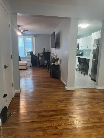 a living room with furniture and a large mirror