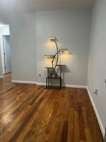 a living room with furniture wooden floor and a view of kitchen