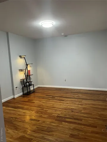 a view of a room with wooden floor and white doors