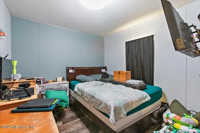 a bedroom with a bed and a dresser in it