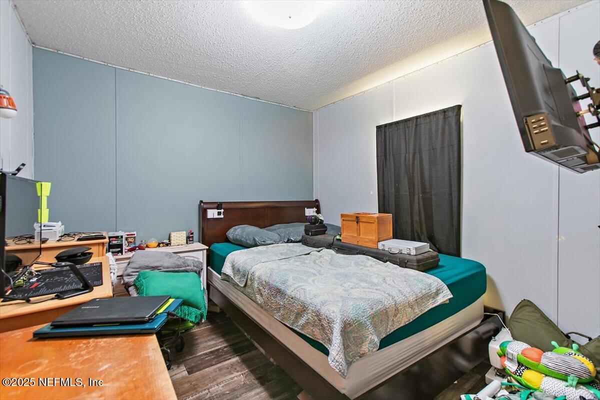 2670 Pleasure Lane St. Augustine, FL 32084 - Photo 8 of 12 a bedroom with a bed and a dresser in it