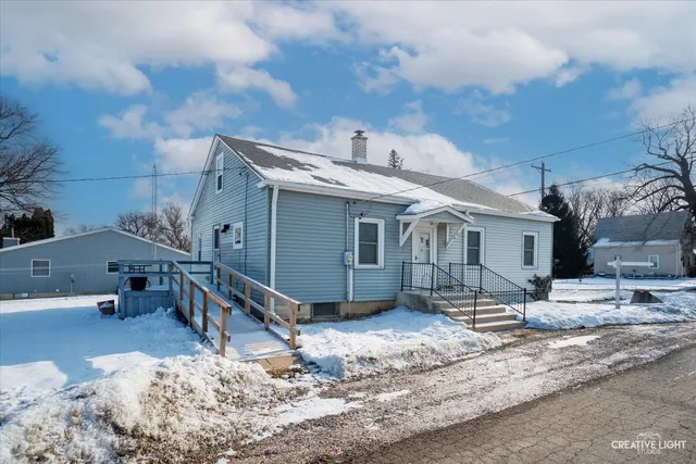 a view of a house with snow in front of it