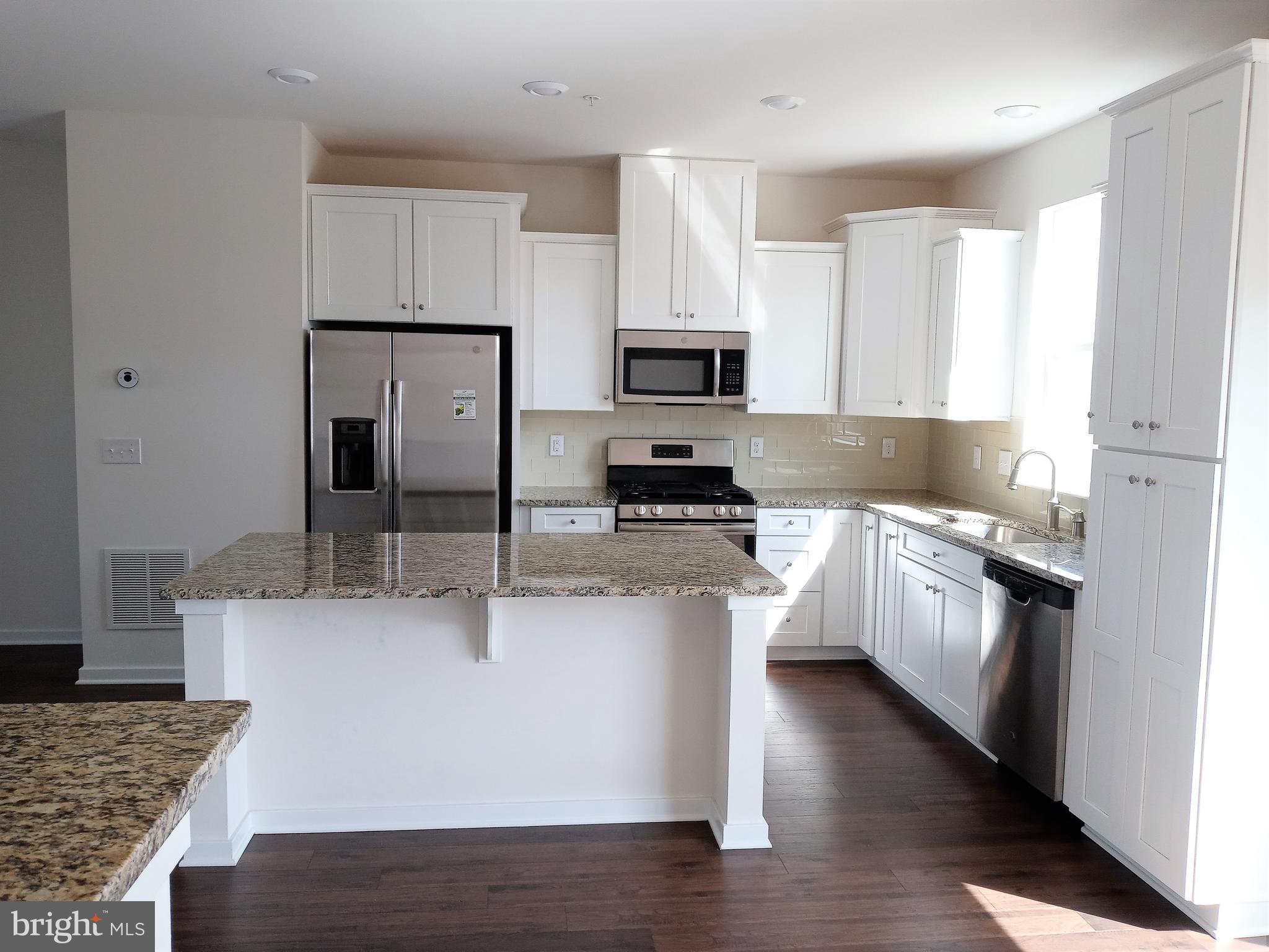 1908 Boulder Drive Downingtown, PA 19335 - Photo 11 of 27 a kitchen with stainless steel appliances granite countertop a stove a sink and a refrigerator
