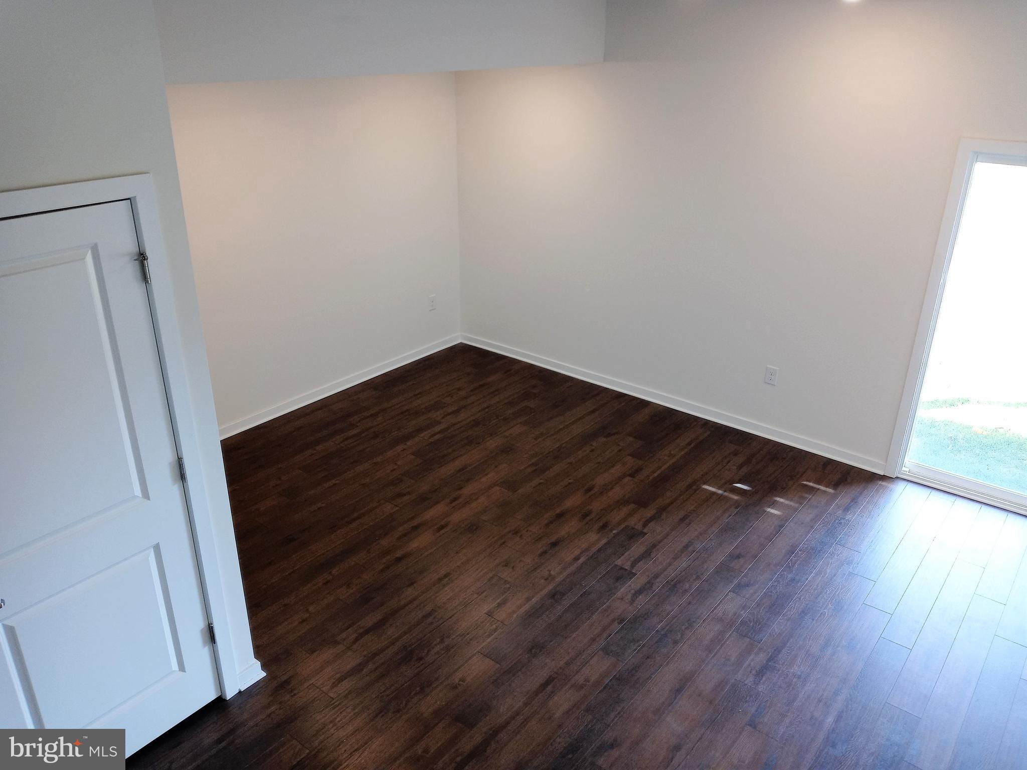 1908 Boulder Drive Downingtown, PA 19335 - Photo 26 of 27 a view of a room with wooden floor and white walls