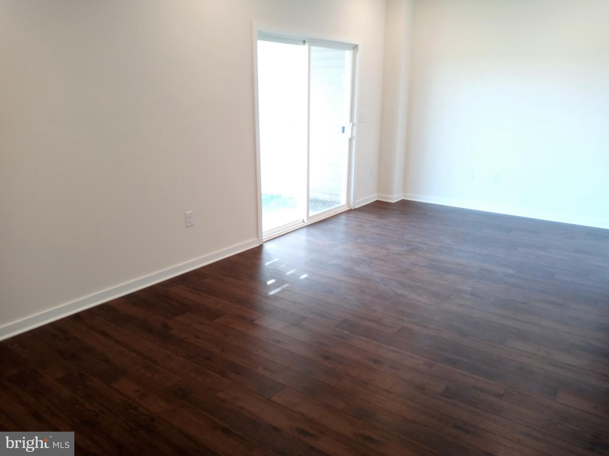1908 Boulder Drive Downingtown, PA 19335 - Photo 27 of 27 an empty room with wooden floor and windows