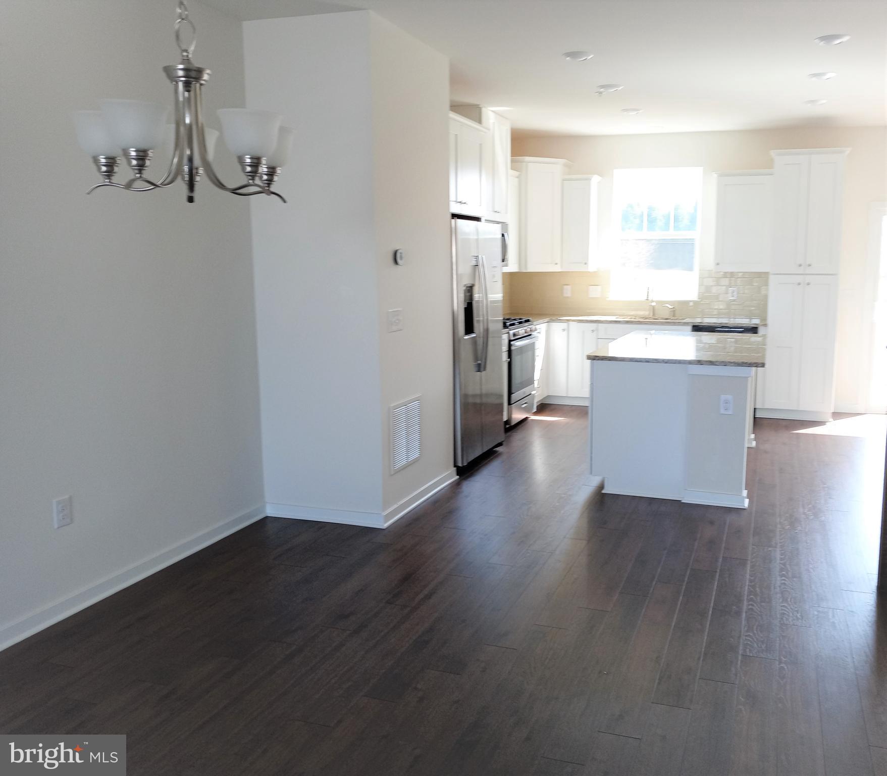 1908 Boulder Drive Downingtown, PA 19335 - Photo 8 of 27 a view of a kitchen with wooden floor and a window
