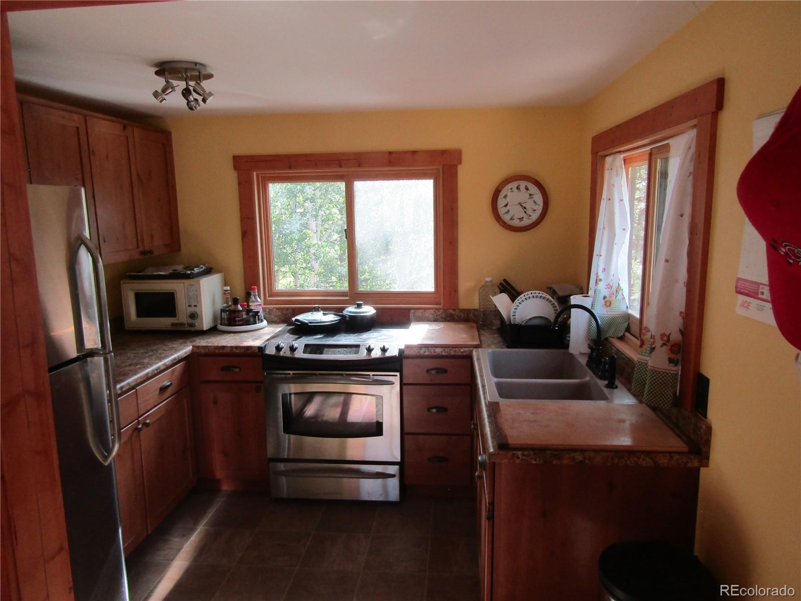 694 Gross Road Bailey, CO 80421 - Photo 17 of 24 a kitchen with stainless steel appliances granite countertop a stove a refrigerator and a microwave