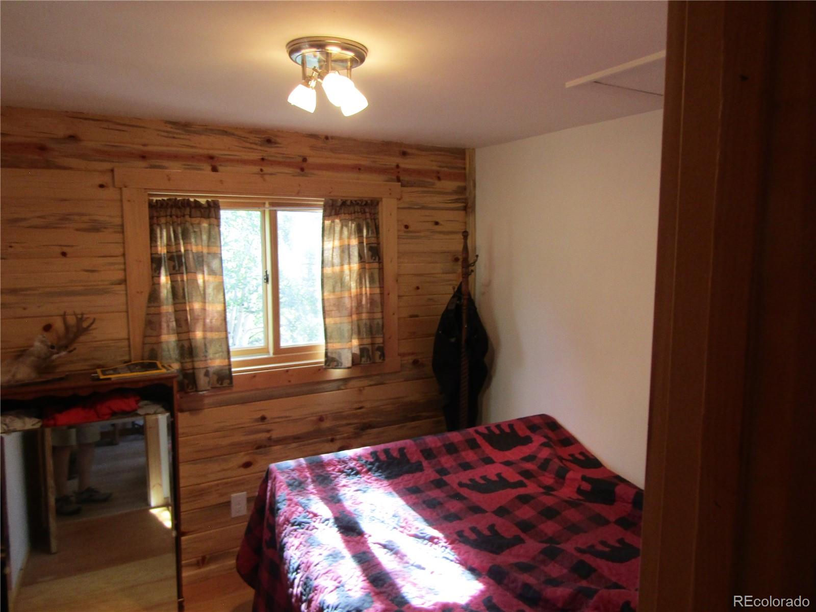 694 Gross Road Bailey, CO 80421 - Photo 20 of 24 a bedroom with a bed and a window