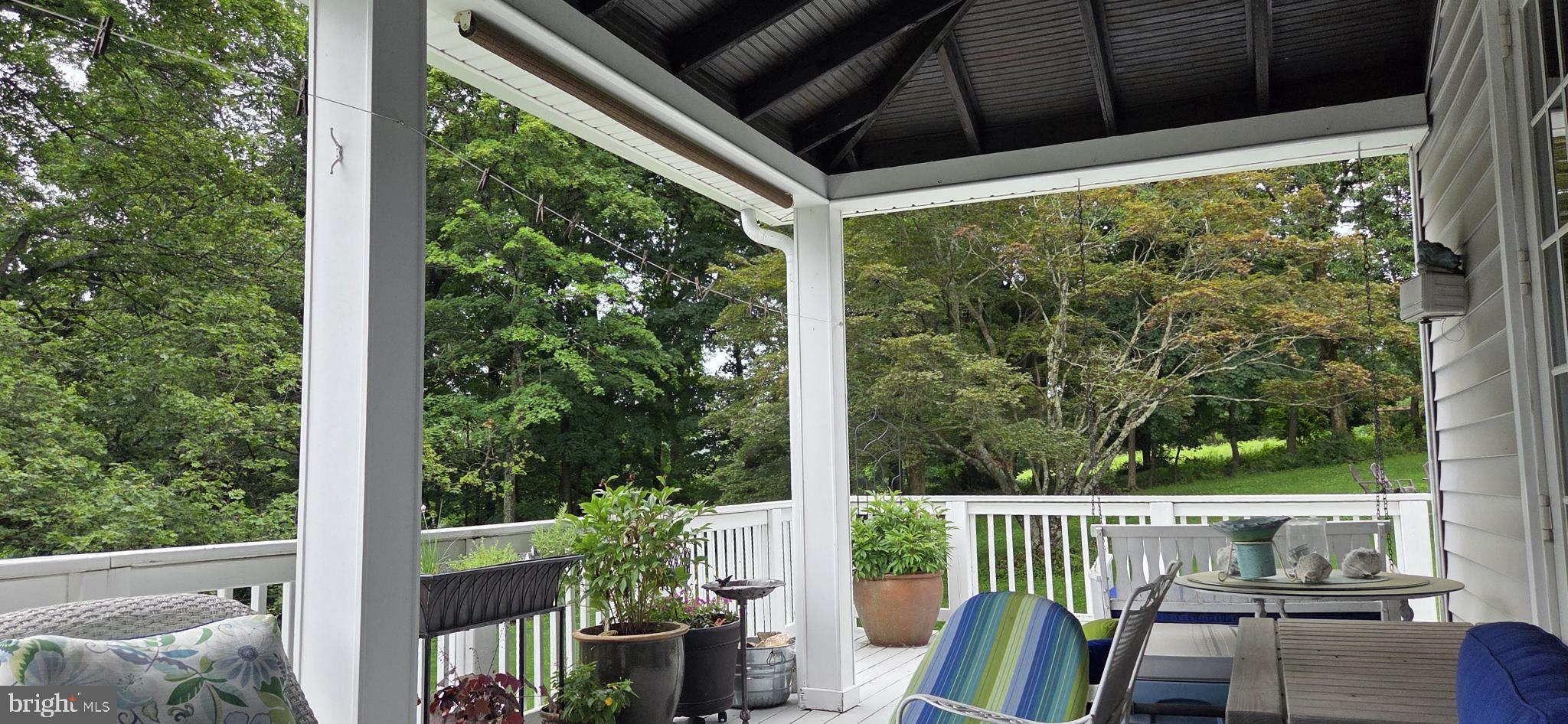 14946 Charmian Road Blue Ridge Summit, PA 17214 - Photo 11 of 56 Serene porch with lush green views.