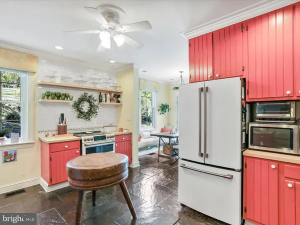 a view of a kitchen with a refrigerator and microwave