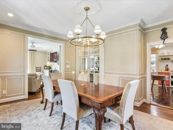 a living room with furniture and a ceiling fan