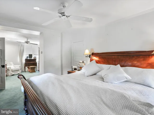 a bathroom with a toilet mirror and sink