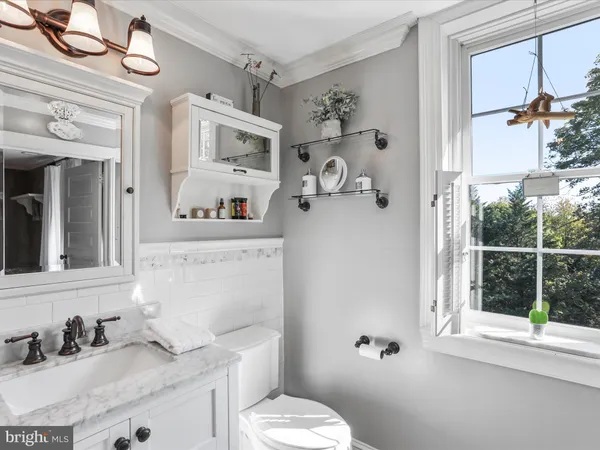 a bathroom with a toilet a sink and a mirror