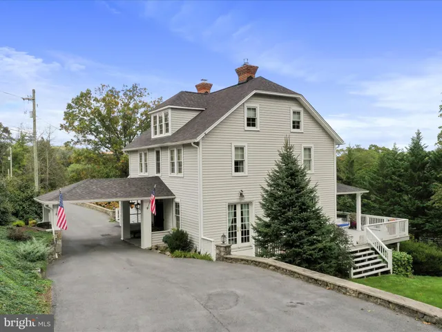 a view of a house with a yard and potted plants