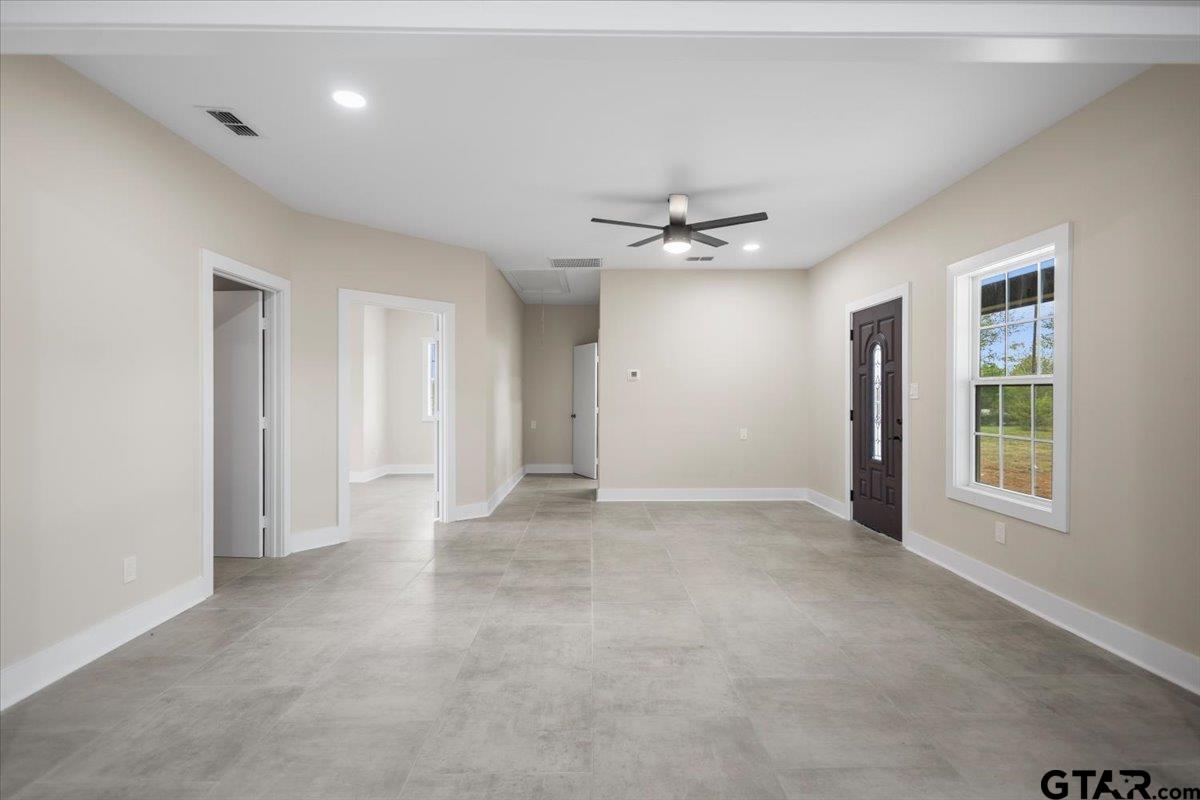 4123 County Road 1120 Tyler, TX 75704 - Photo 19 of 43 an empty room with chandelier fan and windows
