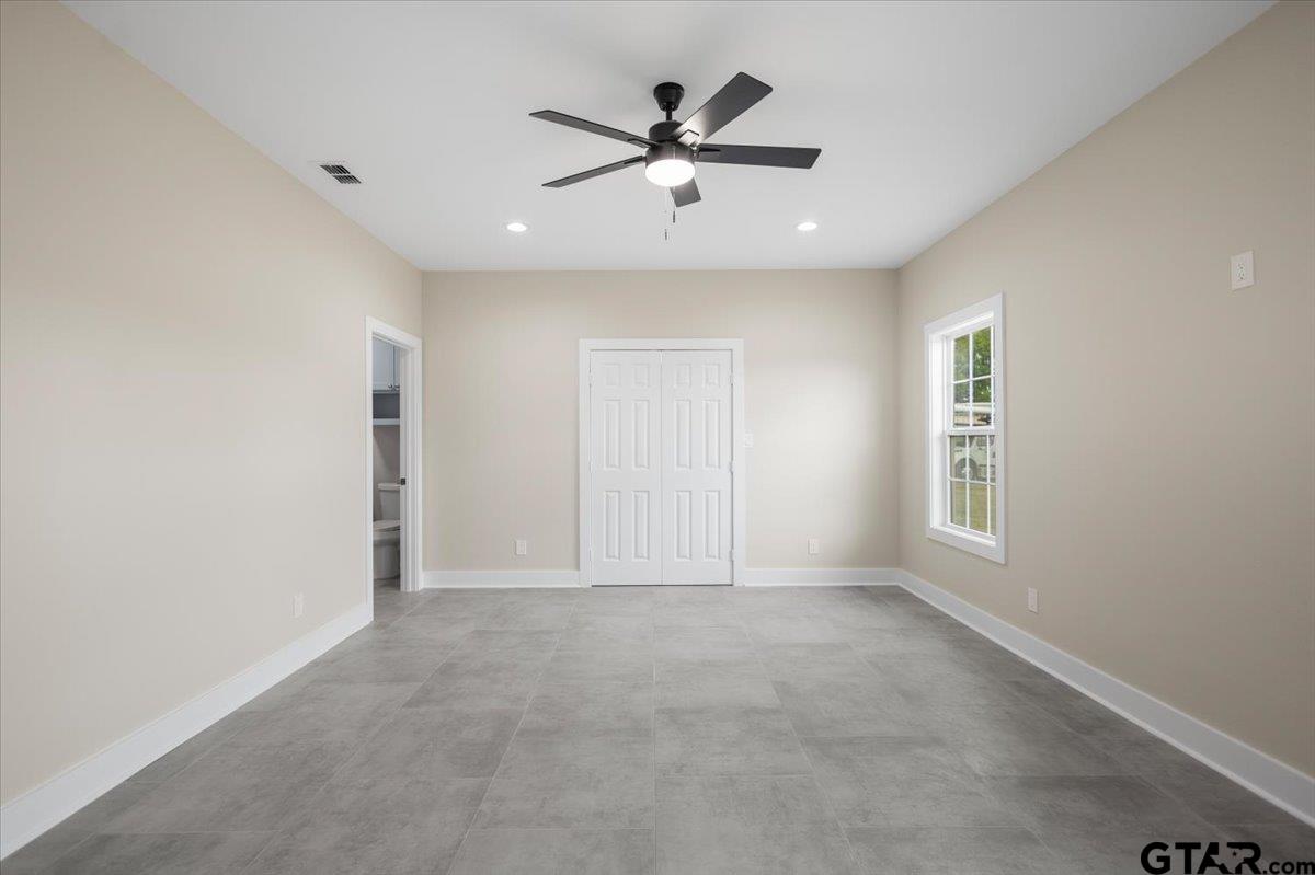 4123 County Road 1120 Tyler, TX 75704 - Photo 21 of 43 a view of an empty room with a ceiling fan