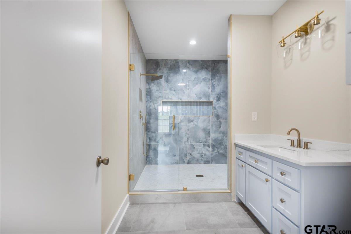 4123 County Road 1120 Tyler, TX 75704 - Photo 26 of 43 a bathroom with a sink a mirror and a bathtub