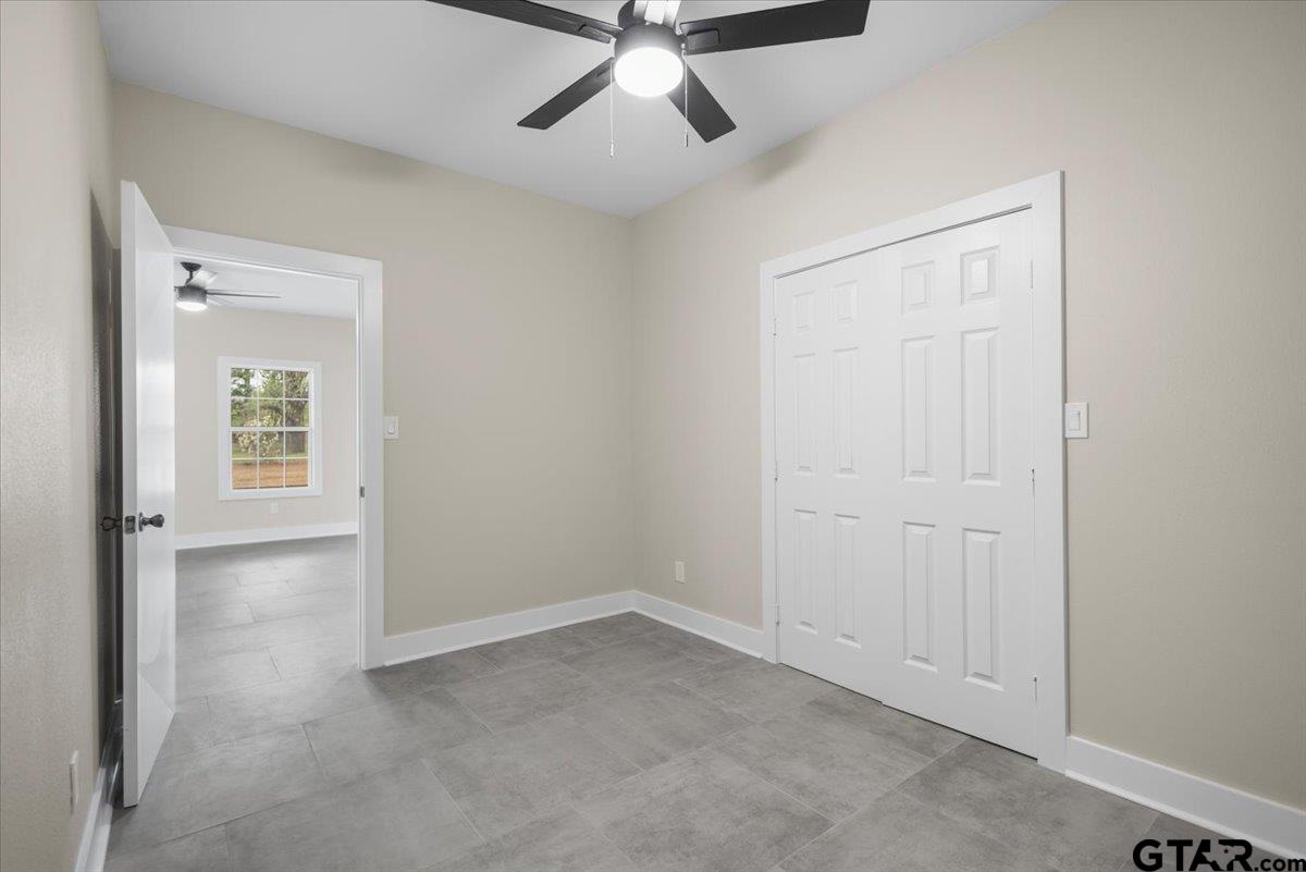 4123 County Road 1120 Tyler, TX 75704 - Photo 28 of 43 an empty room with windows and fan