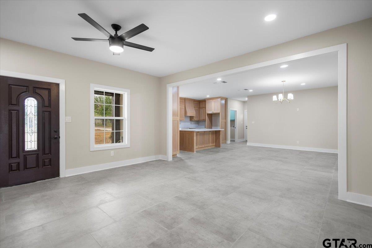 4123 County Road 1120 Tyler, TX 75704 - Photo 30 of 43 an empty room with a kitchen and windows