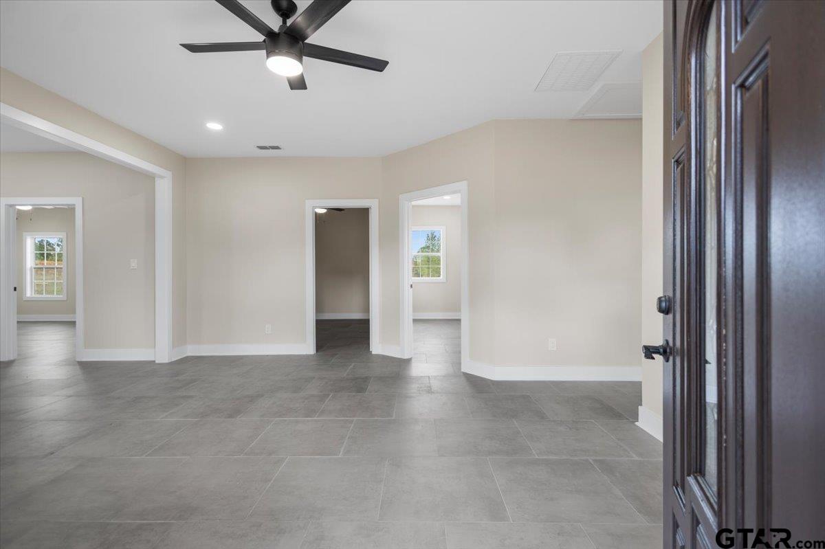 4123 County Road 1120 Tyler, TX 75704 - Photo 36 of 43 wooden floor with a chandelier fan and windows in a room