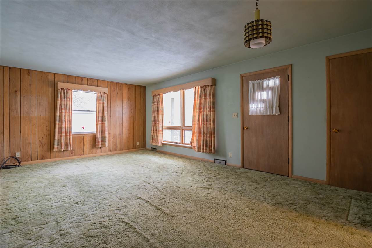 3077 Reid Farm Road Rockford, IL 61114 - Photo 3 of 27 an empty room with windows and fan