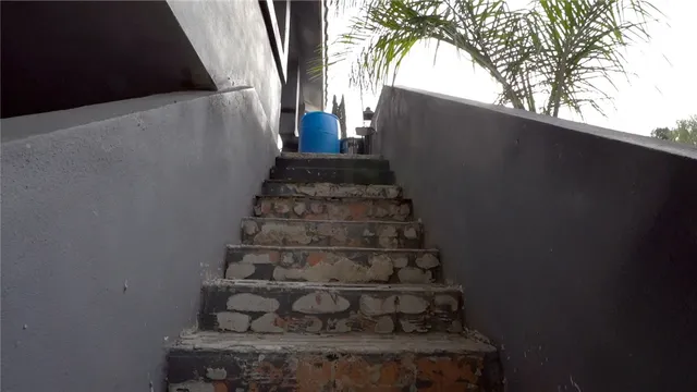 a living room with furniture a chandelier and a large window
