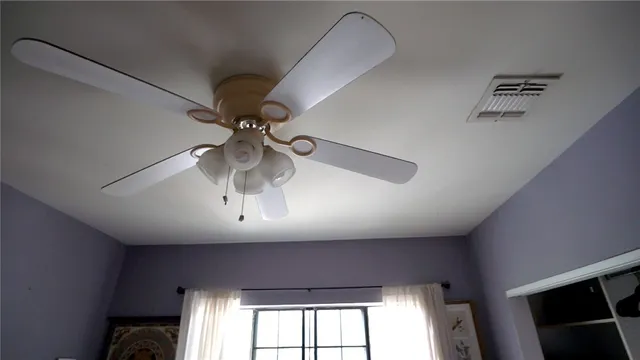 a living room with furniture and large windows