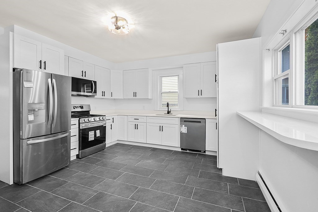 27 Ladd Street, Unit 27 Watertown, MA 02472 - Photo 3 of 10 a kitchen with a refrigerator sink and microwave