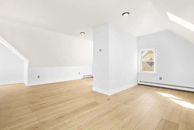 a view of an empty room and wooden floor