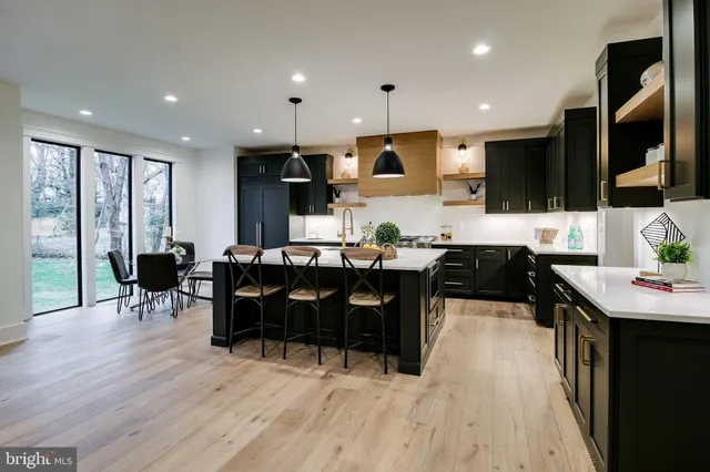 a bed sitting in a bedroom next to a window with a lamp