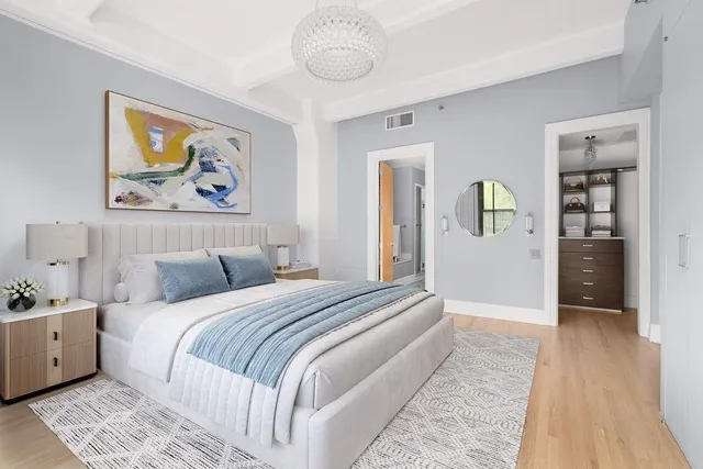 a spacious bedroom with a bed and a large window