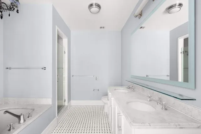 a bedroom with a bed and painting on the wall