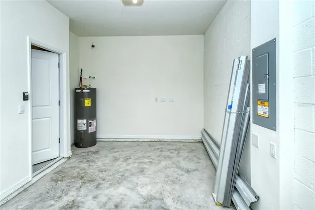 an empty room with a window and wooden floor