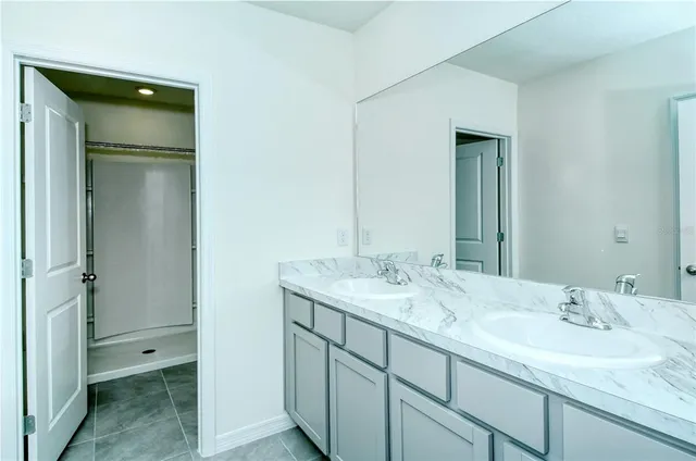 a white toilet sitting next to a shower